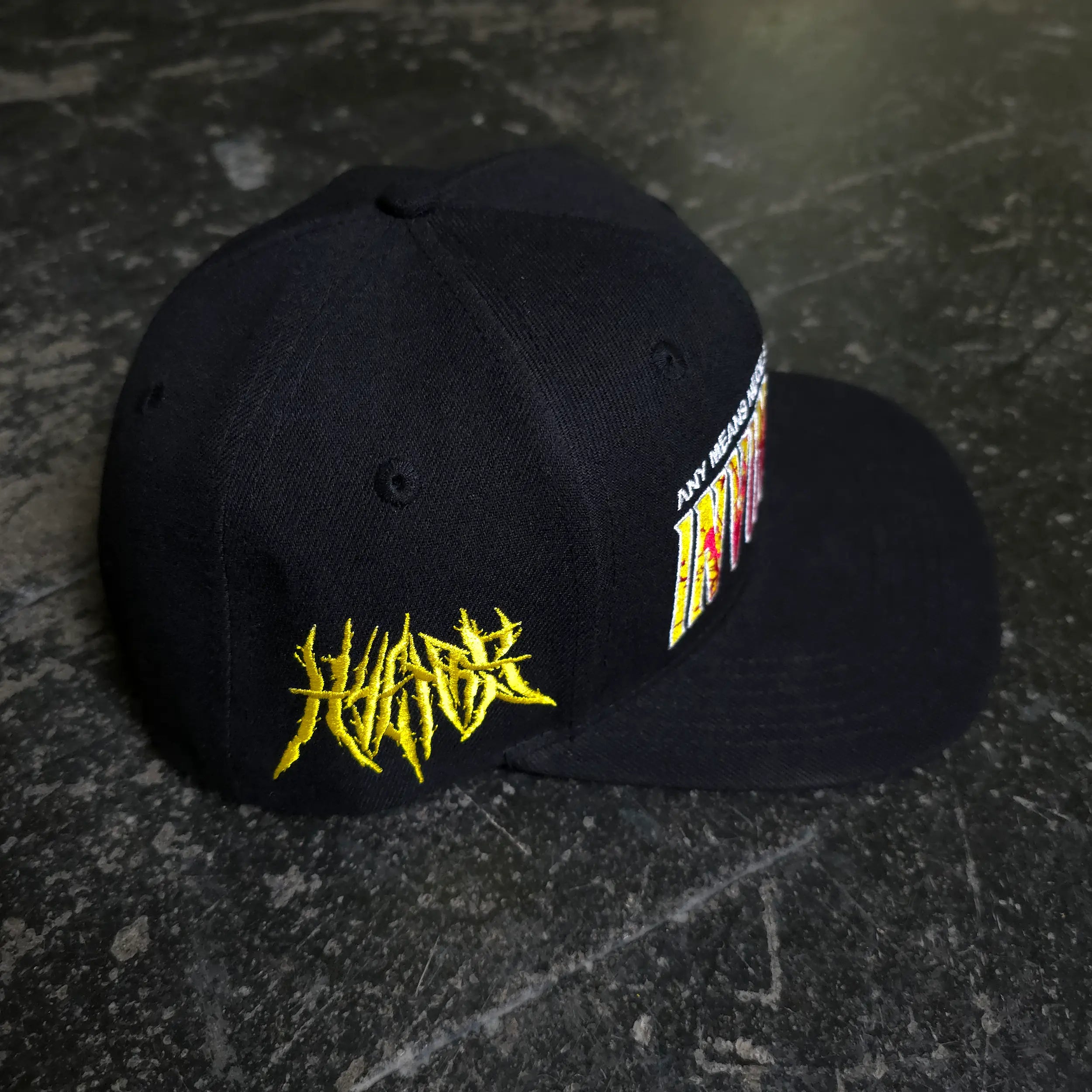 Invincible Splatter Hat by Any Means Necessary Clothing featuring a bold splatter design on a stylish hat.