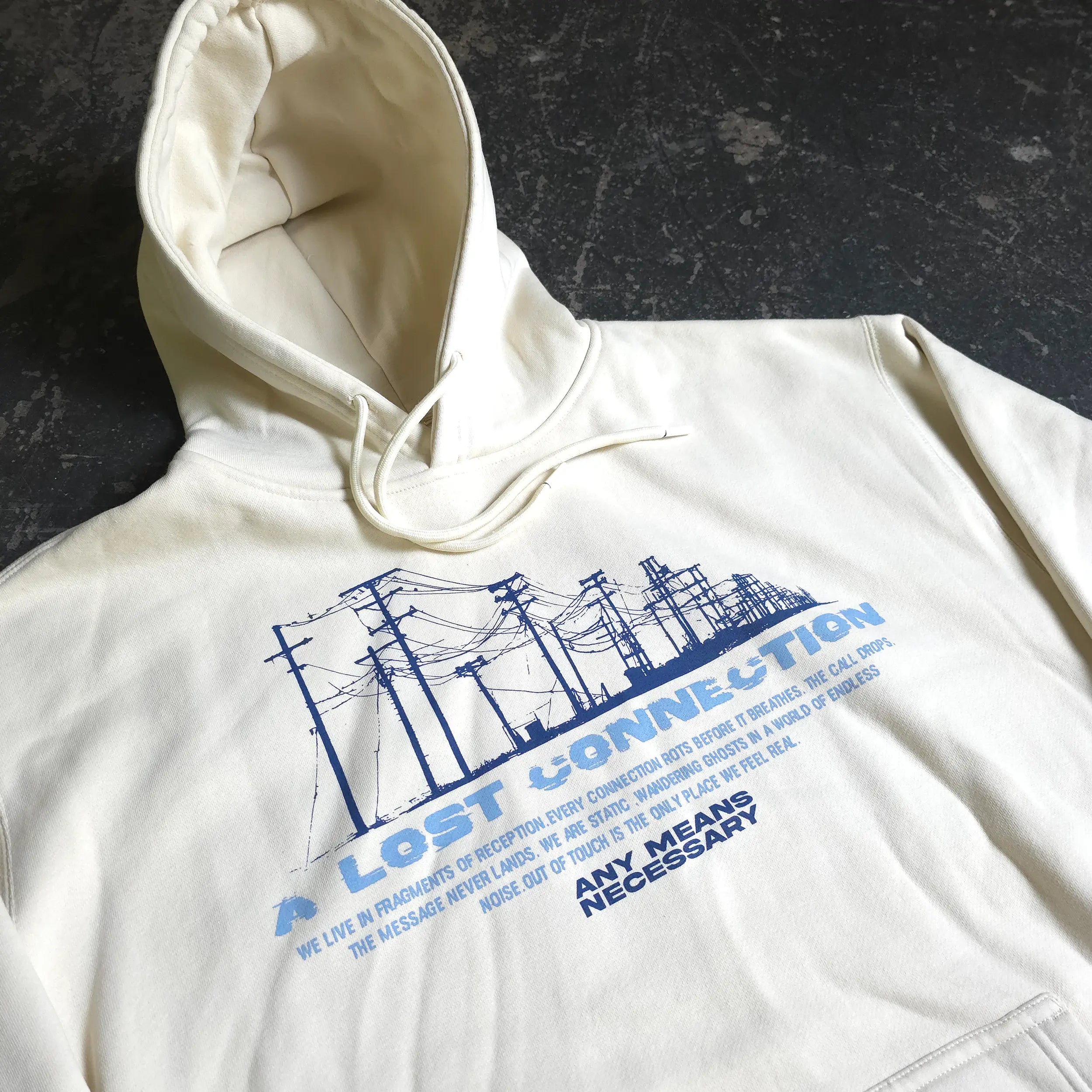 Bone-colored hoodie from Any Means Necessary Clothing with "Lost Connection" text, featuring a casual pullover design.