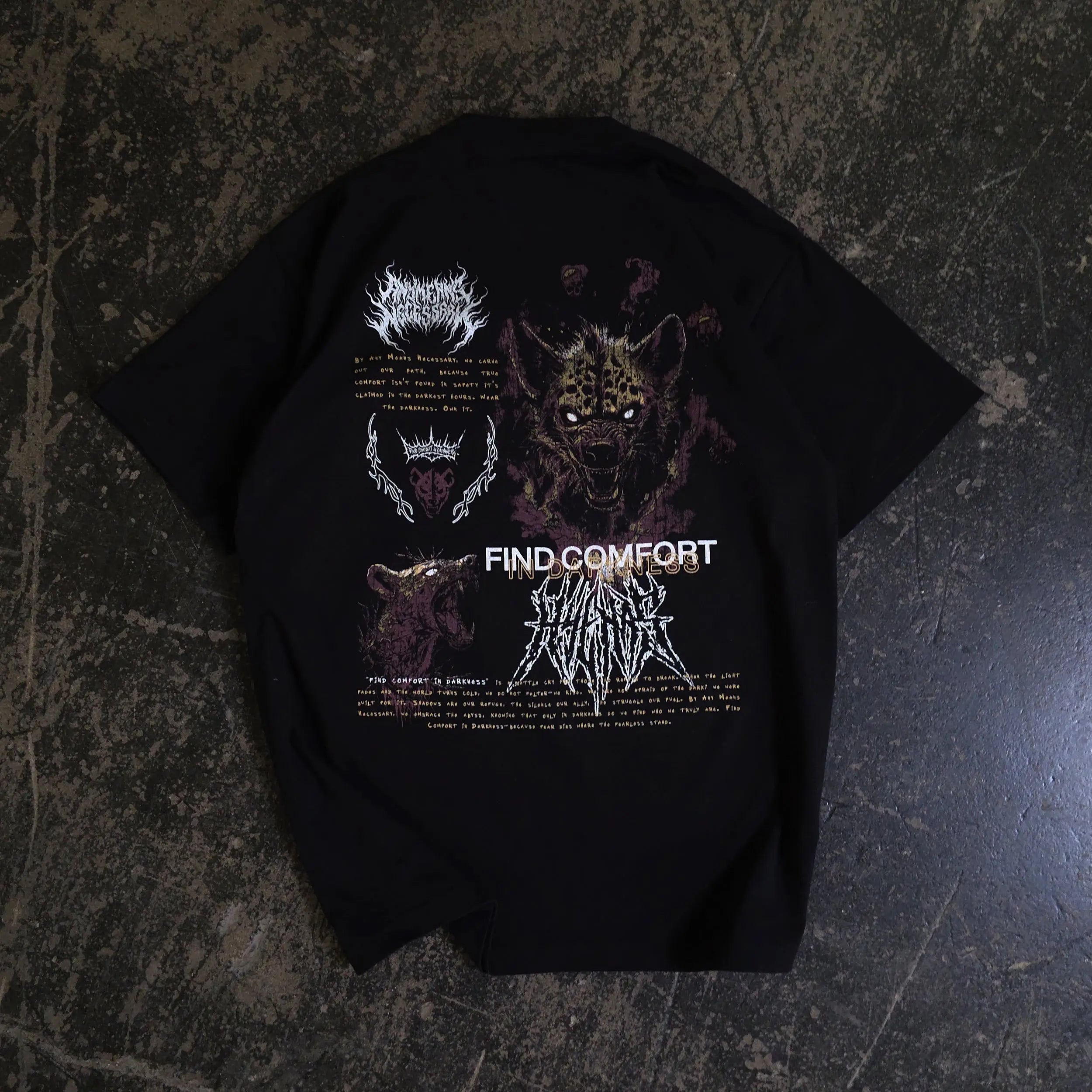 Black Mantra T-Shirt from Any Means Necessary Clothing featuring a bold printed design on the front.