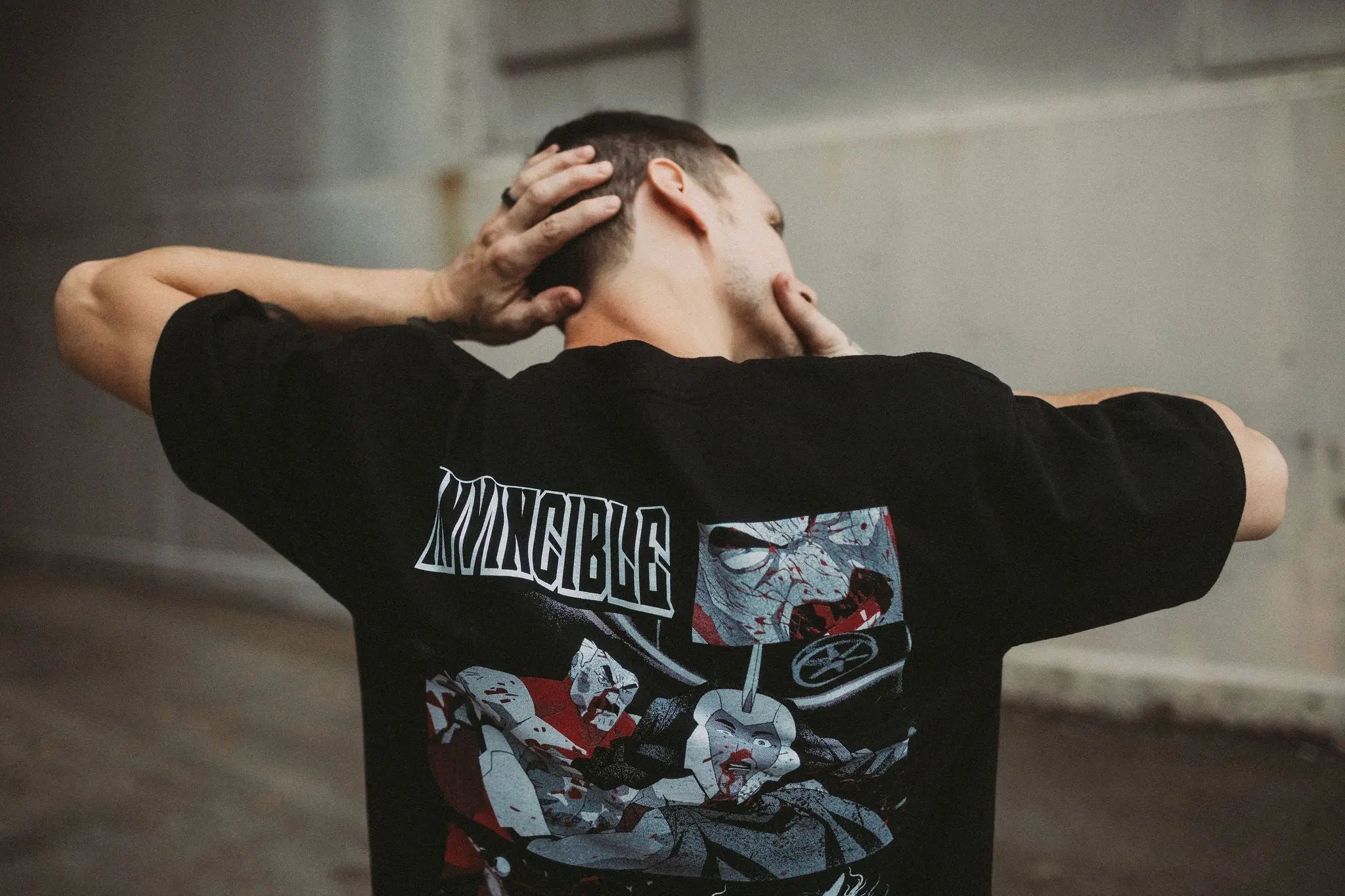 Black Neck Snap T-Shirt by Any Means Necessary Clothing, featuring a snap detail at the neckline and casual shirt style.