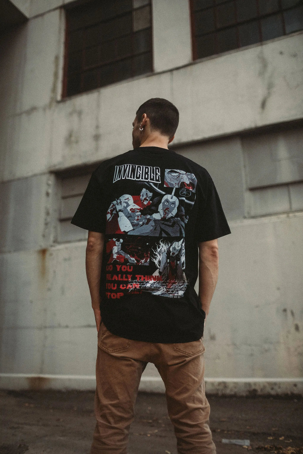 Black Neck Snap T-Shirt from Any Means Necessary Clothing featuring a casual fit and snap button neckline.