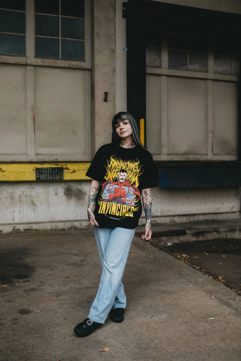 Black Omni-Man T-shirt from Any Means Necessary Clothing featuring a graphic print of Omni-Man superhero design.