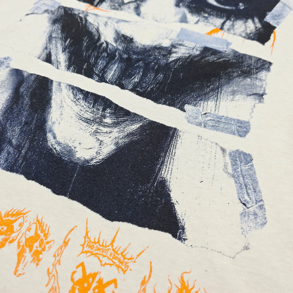 White "What Lies Beneath" bone graphic T-shirt from Any Means Necessary Clothing, showcasing a casual shirt design.