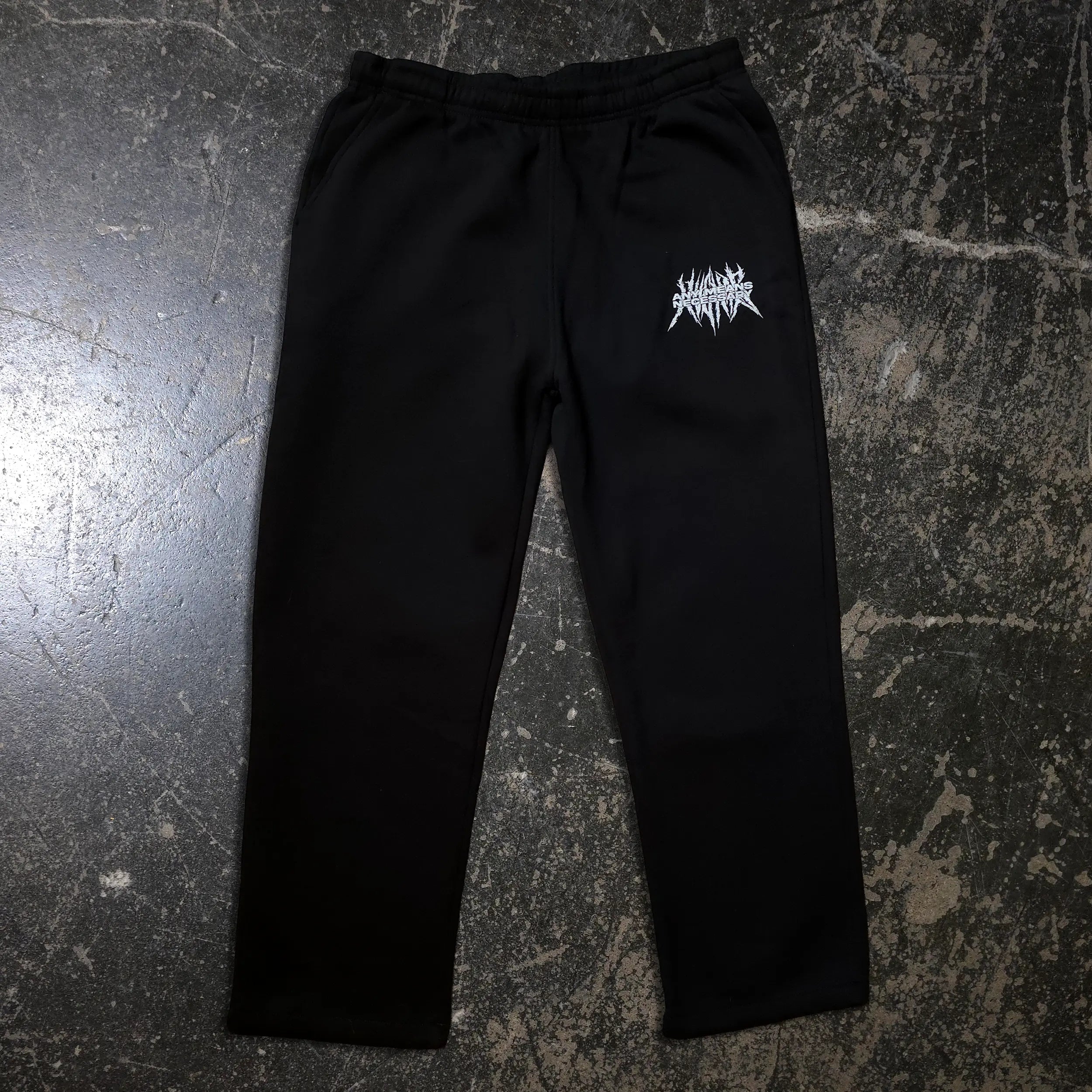 Black Mantra Sweatpants by Any Means Necessary Clothing, shown with relaxed fit and drawstring waist.