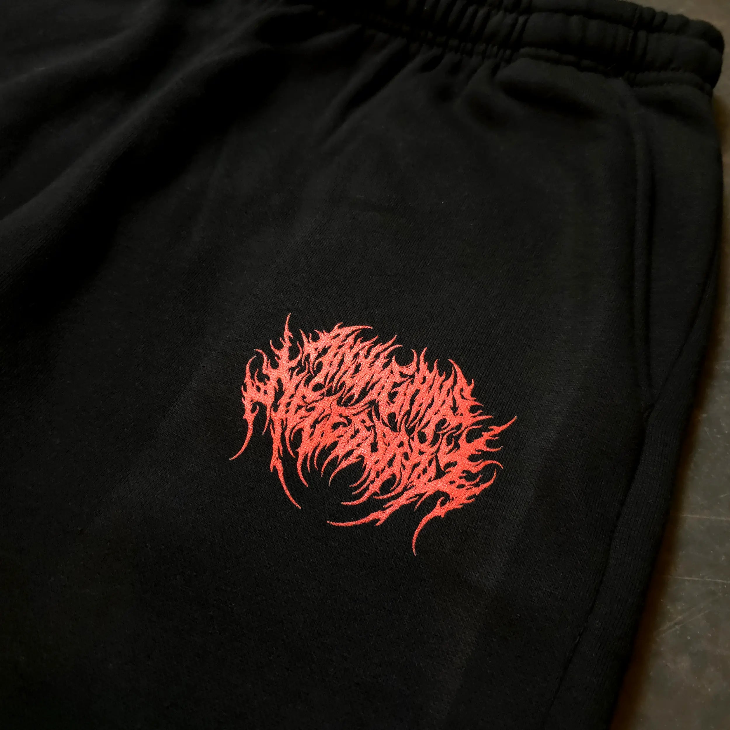 Black When Death Comes sweatpants by Any Means Necessary Clothing, with a relaxed fit and graphic design on the front.